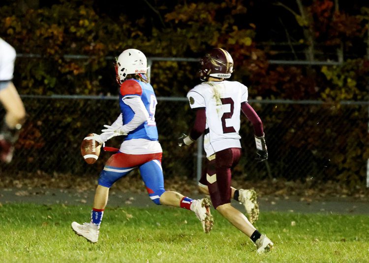 Midland Trail’s Cody Harrell (9) crosses the goaline for a touchdown on a carry as Pocahontas County’s Ryan Halterman (2) looks on during their high school football game in Hico on Friday, Nov. 5, 2021 (Photo by Chris Jackson)