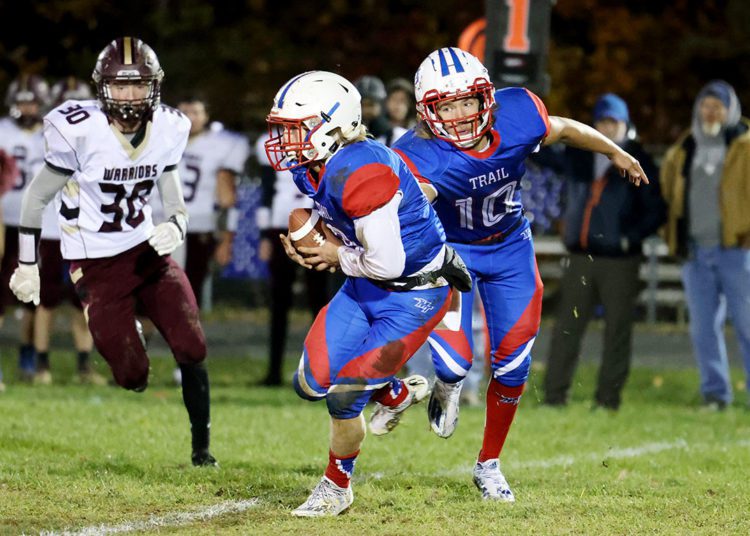 Midland Trail’s Joshua Dickerson (10) hands off to Robert Ruffner (8) during for their high school football game against Pocahontas County in Hico on Friday, Nov. 5, 2021 (Photo by Chris Jackson)