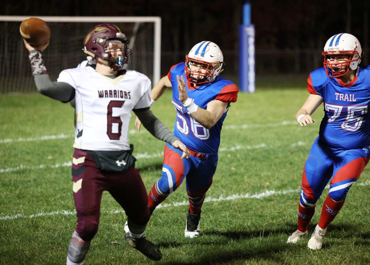 Midland Trail’s Danny Nottingham (56) and Peyton Kirk (75) pursue Pocahontas County’s Braedan Hayhurst (6) during their high school football game in Hico on Friday, Nov. 5, 2021 (Photo by Chris Jackson)