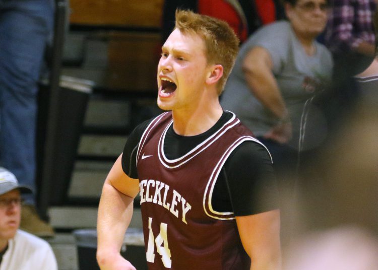 (Brad Davis/For LootPress) Woodrow Wilson's Maddex McMillen skips around the court in celebration after his late three-pointer sank rival Greenbrier East Friday night in Fairlea.