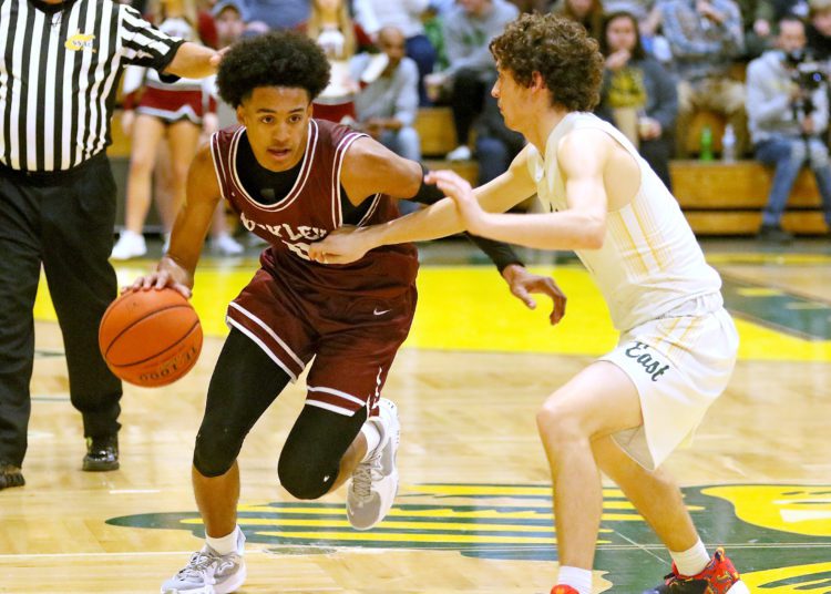 (Brad Davis/For LootPress) Woodrow Wilson's Keynan Cook drives around Greenbrier East's Zach Patton Friday night in Fairlea.