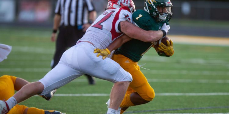 RYAN FISCHER | HD Media
Hurricane linebacker Brogan Brown wraps up Huntington ball-carrier Amari Felder in a 2020 game.