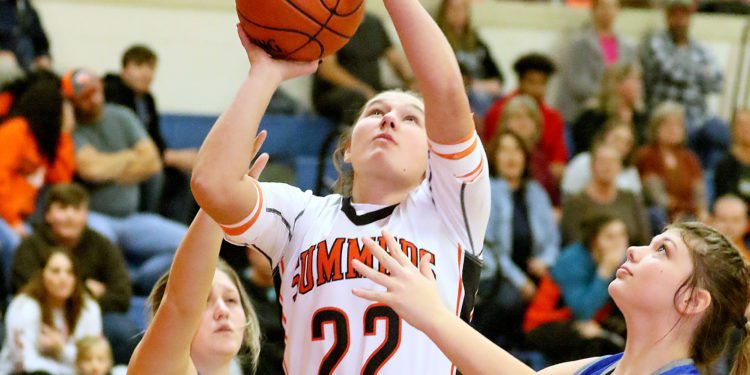 (Brad Davis/For The LootPress) Summers County's Maggie Stover drives to the basket Montcalm's Jaden Lambert, left, and Kalileig Hodges defend during Friday action at the Rogers Oil Classic in Hinton.