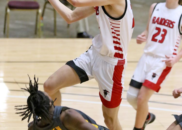 (Brad Davis/For LootPress) Liberty's Adam Drennen drives and scores as Mount View's Tony Bailey tries to draw a charge during New River Invitational action Wednesday night in Beckley.