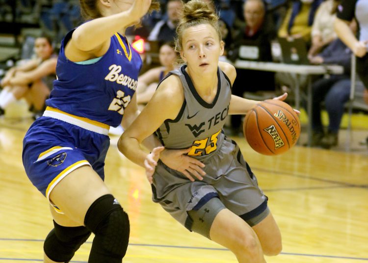(Brad Davis/For LootPress) WVU Tech's Brittney Justice drives to the basket as Brescia's Hallie Fisher defends Saturday afternoon in Summersville.