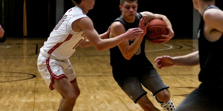 Westside's Evan Colucci (right) drives by a defender during the team's game against Webster County in the New River CTC Invitational on Jan. 3 (Karen Akers/Lootpress)
