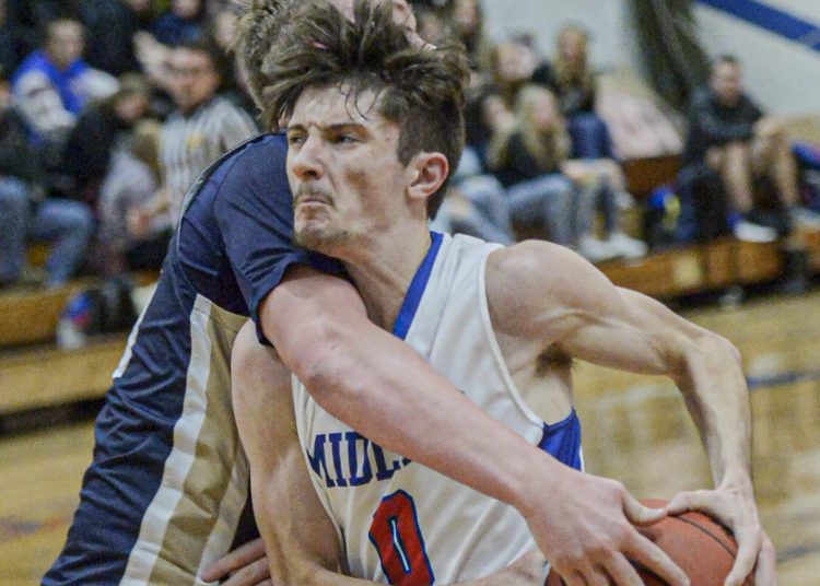 Midland Trail’s Matthew Light is wrapped up as he drives for the rim. F. Brian Ferguson/Lootpress.