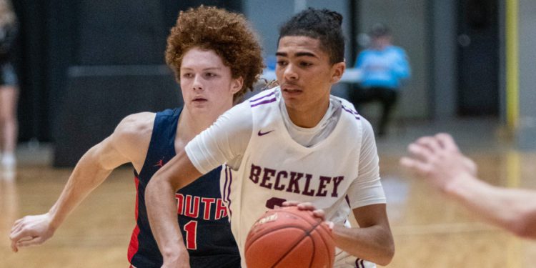 Beckley's Elijah Redfern drives by Parkersburg South's Cyrus Traugh during a game in Beckley on Feb. 24. (Heather Belcher/Lootpress)