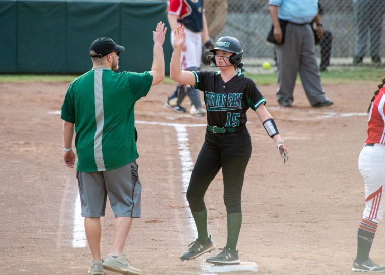 Wyoming East's Olivia Hylton high fives assistant coach Travis McKinney during a game against Independence on March 30. (Heather Belcher)