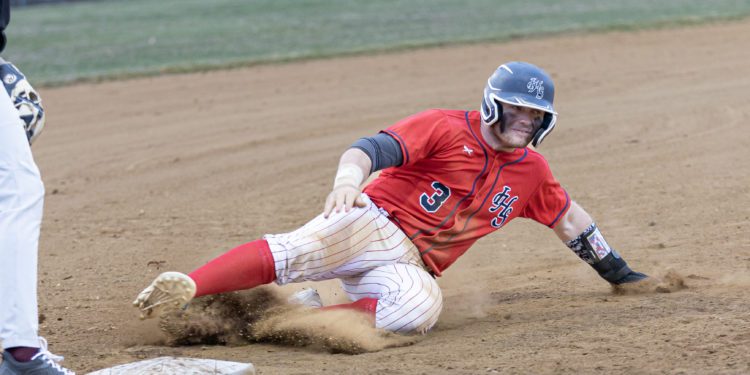 Independence's Atticus Goodson slides into a base during game against George Washington on March 22. (File Photo by Tina Laney)
