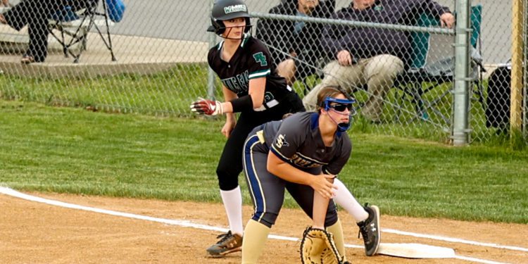 Wyoming East's Olivia Hylton slides off first base behind Shady Spring's Hadley Wood during a regional game at Shady Spring on May 17.