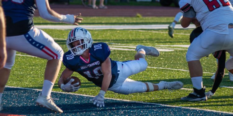 Independence's Judah Price lunges for the end zone against Liberty (Heather Belcher/Lootpress)