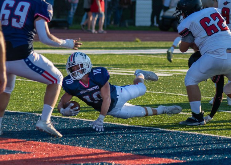 Independence's Judah Price lunges for the end zone against Liberty (Heather Belcher/Lootpress)