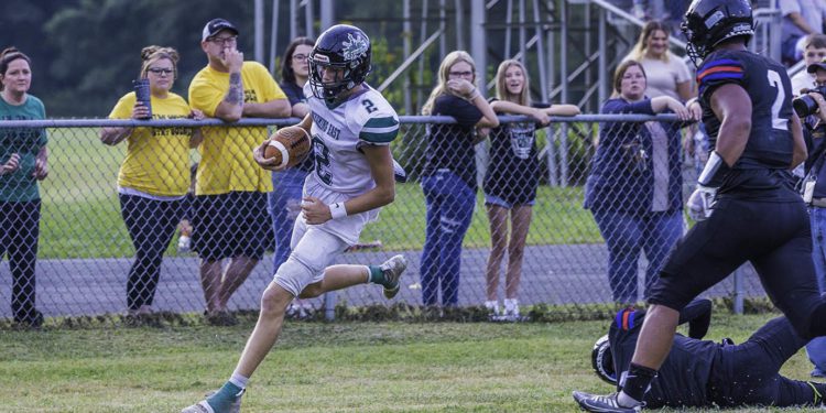 Wyoming East's Jackson Danielson scrambles during a play against Westside on Aug. 26
(File Photo by Tina Laney)