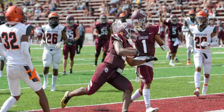 Concord's Jarod Bowiw (1) congratulates Kris Copeland after scoring a TD in a game last season. (File Photo by Greg Barnett)