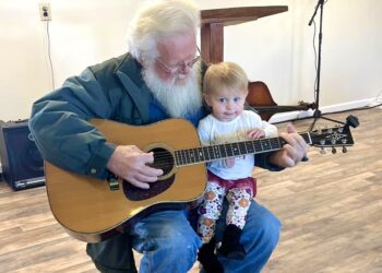 Mr. Cherry and his granddaughter playing the guitar prior to its disappearance. Photo credit: Dennis Cherry