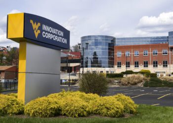 New signage for the WVU Innovation Corporation stands in front of the former Mylan facility as seen Wednesday, April 13, 2022. (WVU Photo/Jennifer Shephard)