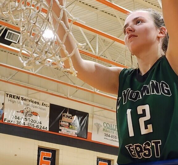 Russell cuts down the net after a regional win against Chapmanville.