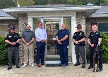 From left to right, Sheriff Brett Carpenter, Commissioner Jamie Carpenter, Commissioner Jed Schola, Commissioner David Strait, Chief Deputy Jeff Roy, Deputy Christian Male and canine "Creed".