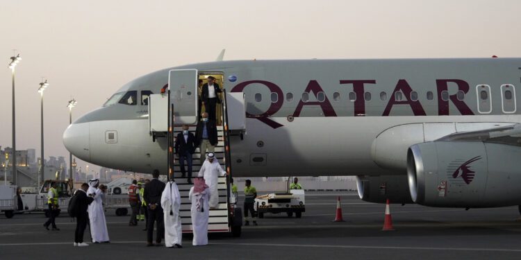 Emad Sharghi, Morad Tahbaz and Siamak Namazi, former prisoners in Iran, walk out of a Qatar Airways flight that brought them out of Tehran and to Doha, Qatar, Monday, Sept. 18, 2023. Five prisoners sought by the U.S. in a swap with Iran were freed Monday and headed home as part of a deal that saw nearly $6 billion in Iranian assets unfrozen. (AP Photo/Lujain Jo)