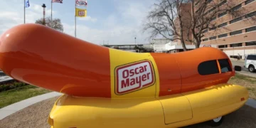 The Oscar Mayer Wienermobile sits outside the the Oscar Meyer headquarters, Oct. 27, 2014, in Madison, Wis. On Wednesday, Sept. 20, 2023, four months after announcing that the hot dog-shaped Wienermobile was changing its name to the Frankmobile, Oscar Meyer said that the one-of-a-kind wiener on wheels is reverting to the original. (M.P. King/Wisconsin State Journal via AP, File)