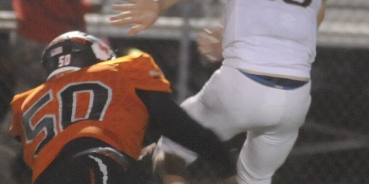 Martinsburg defensive tackle Rashad Reid dives after Jefferson quarterback Dylan Harich in quest of making a sack. Reid won the Stydahar and Huff awards from the West Virginia Sports Writers Association.