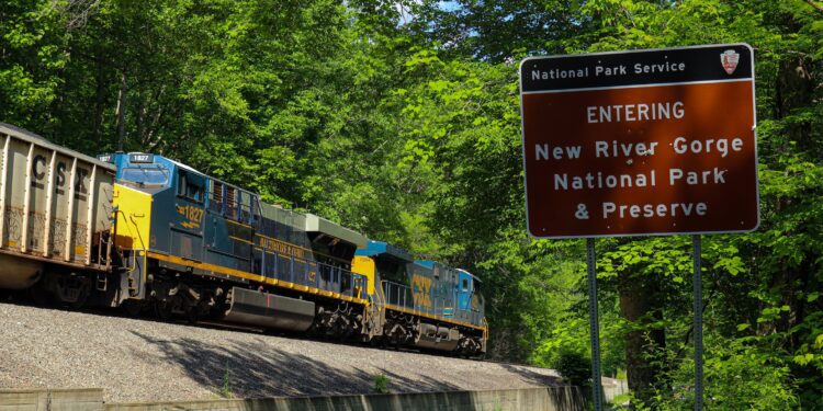 The CSX Baltimore & Ohio (B&O) heritage unit leads on a coal train bound for Thurmond. Seen here entering New River Gorge National Park & Preserve.