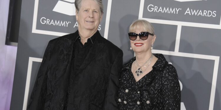Musician Brian Wilson, left, and his wife Melinda Ledbetter Wilson arrive at the 55th annual Grammy Awards on Sunday, Feb. 10, 2013, in Los Angeles. A judge found Thursday that Beach Boys founder and music luminary Brian Wilson should be in a court conservatorship to manage his personal and medical decisions because of what his doctor calls a "major neurocognitive disorder." (Photo by Jordan Strauss/Invision/AP, File)