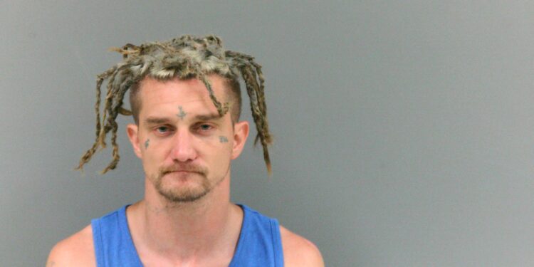 Man ties child up to pole in front of house