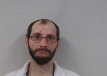 A man is facing charges after headbutting a woman and dragging her around the house. 