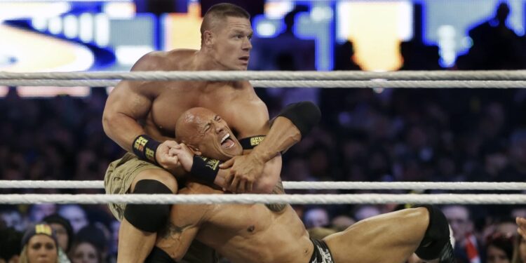 Wrestler John Cena, top, chokes Dwayne Douglas

Johnson, known as The Rock, as they wrestle, April 7, 2013, in East

Rutherford, N.J., during Wrestlemania. Cena announced Saturday,

July 6, 2024, that he will retire from professional wresting next

year after two decades in the ring. (AP Photo/Mel Evans, File)