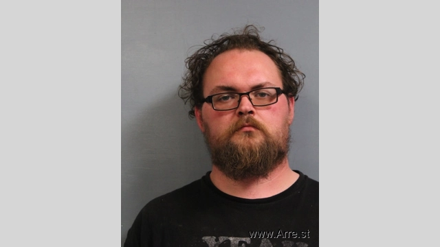 A man was charged with child abuse after forcibly holding an infant's head down against a mattress in the crib.