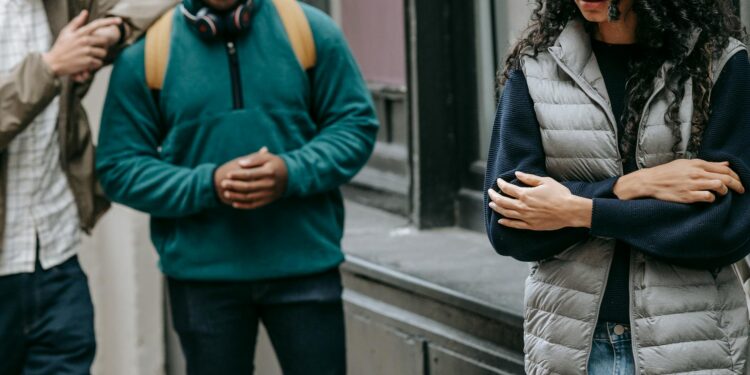 multiracial friends bullying female on street