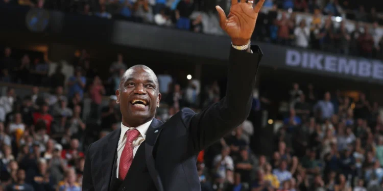 Retired Denver Nuggets center Dikembe Mutombo waves to the crowd as his jersey number was retired by the team during halftime of the Nuggets' NBA basketball game against the Portland Trail Blazers on Saturday, Oct. 29, 2016, in Denver. (AP
Photo/David Zalubowski, File)
