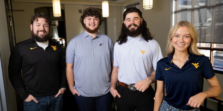 The 2025 WVU Mountaineer mascot finalists Thaiddeus “Ted” Dillie, from left, Cade Kincaid, Justin Waybright and Rachel Morgan will lead the crowd during a cheer-off as part of the mascot selection process during the men’s basketball game Tuesday (Feb. 25) in the Coliseum. (WVU Photo/Matt Sunday)