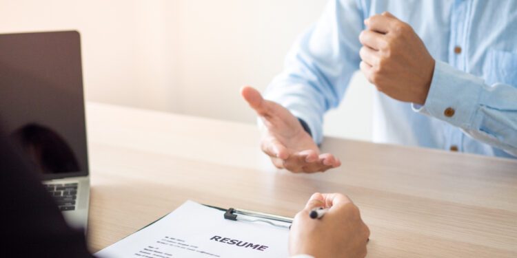 The applicant is introducing himself and explain the methods and techniques of working together with others in front of the executives to consider employment in the company. Resume and job interview.