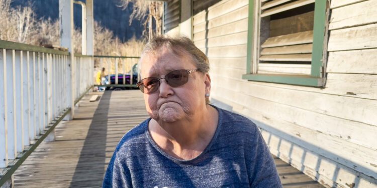 Brown sits on the porch of her former Thurmond residence.