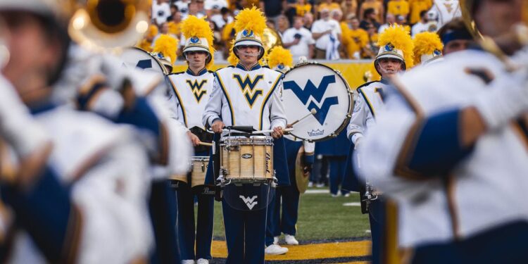 The WVU Mountaineer Marching band performs at a 2024 football game. A challenge gift from WVU alumnus David K. Hendrickson on WVU Day of Giving helped raise more than $150,000 to support the Pride Practice Field and Facility. (WVU Photo/Garrett Cullen)