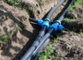 Installed PVC water pipes in trench at summer cottage. Plumbing system outside home concept